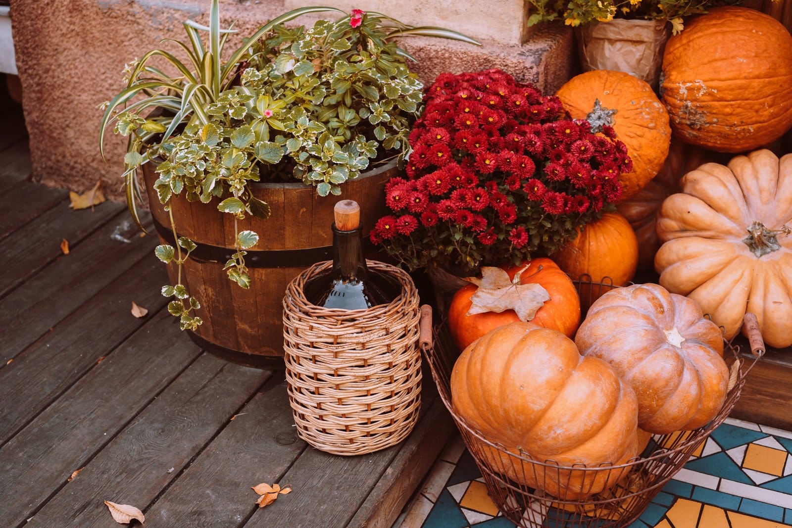 Autumn porch decor with pumpkins and flowers
