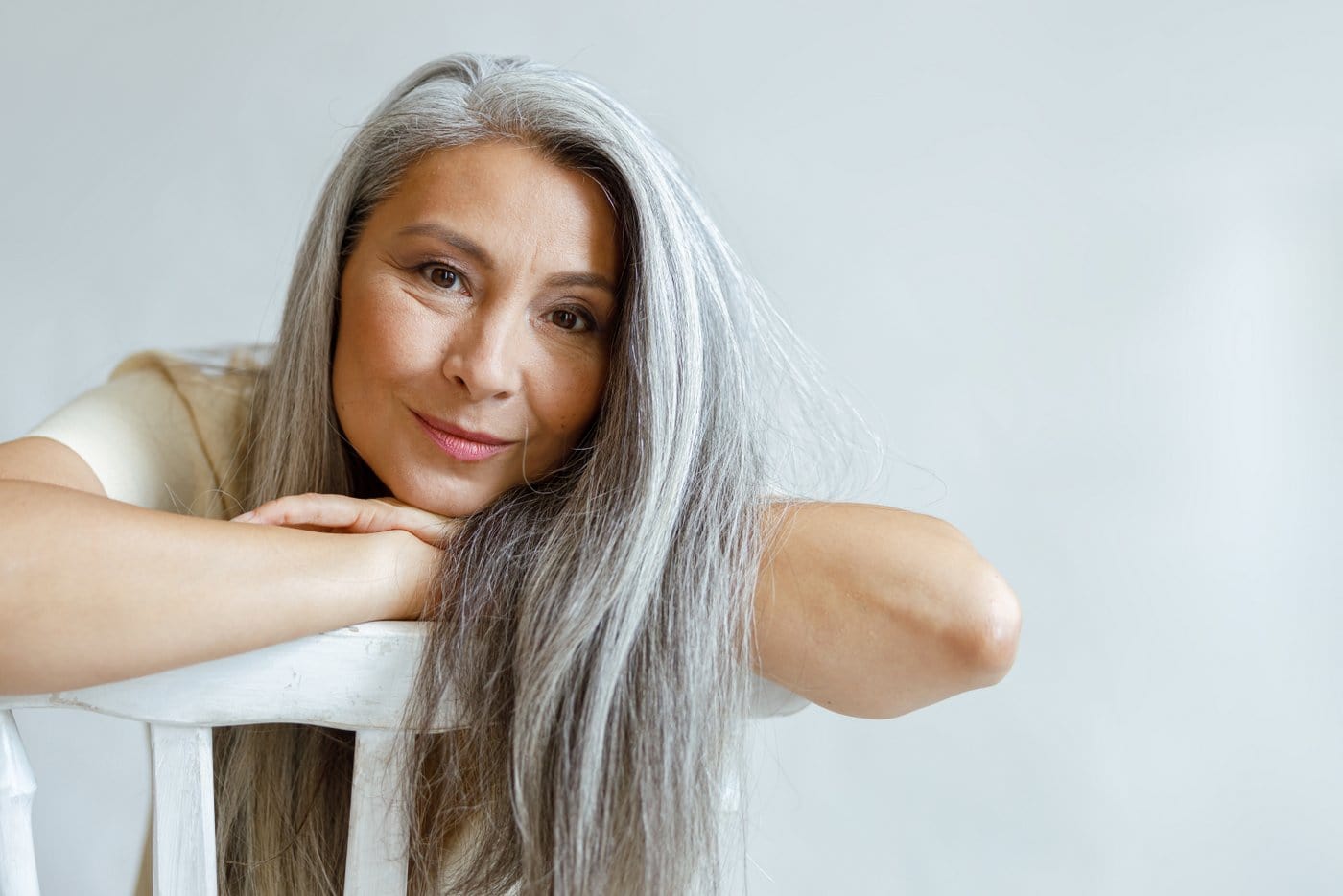 Beautiful woman with gray hair in a chair