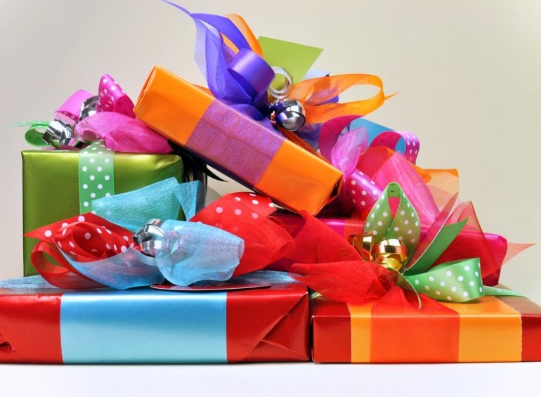 Brightly-colored wrapped gifts with bows