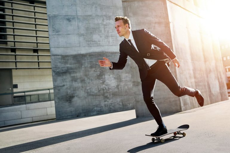 Businessman riding a skateboard