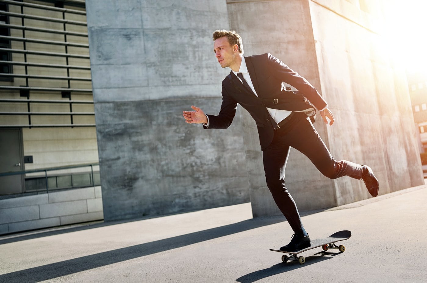 Businessman riding a skateboard