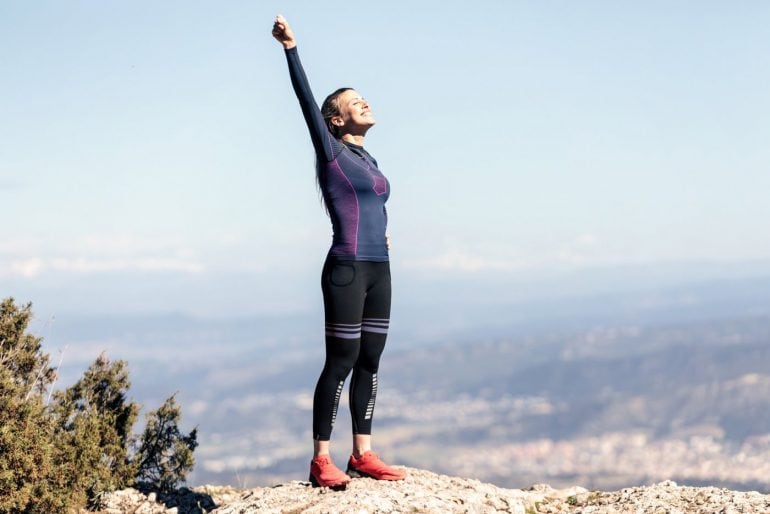Confident runner happy at top of mountain