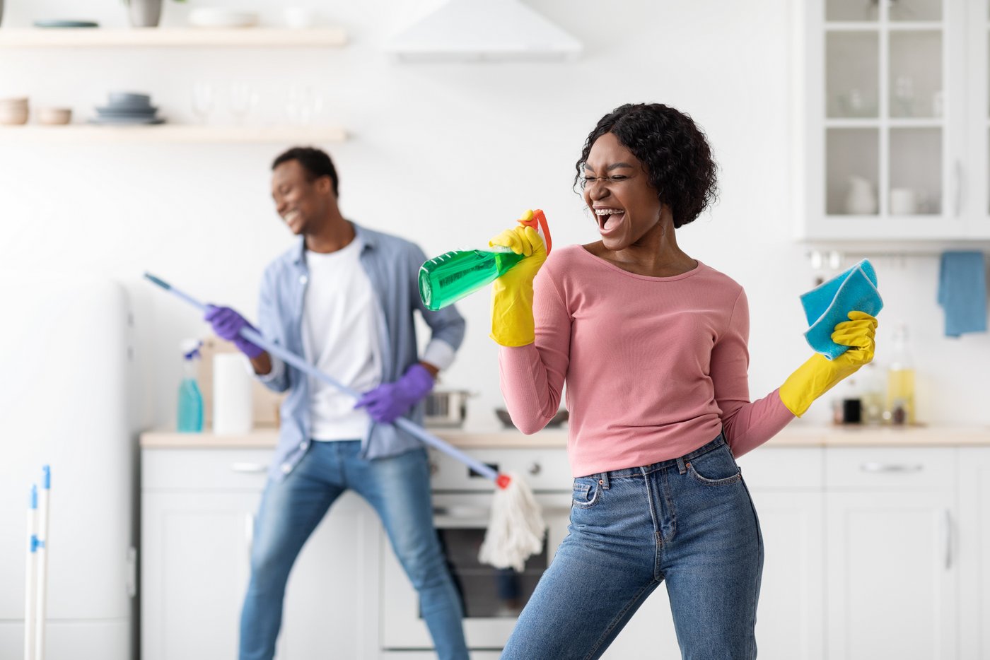 Family members having fun while cleaning the house