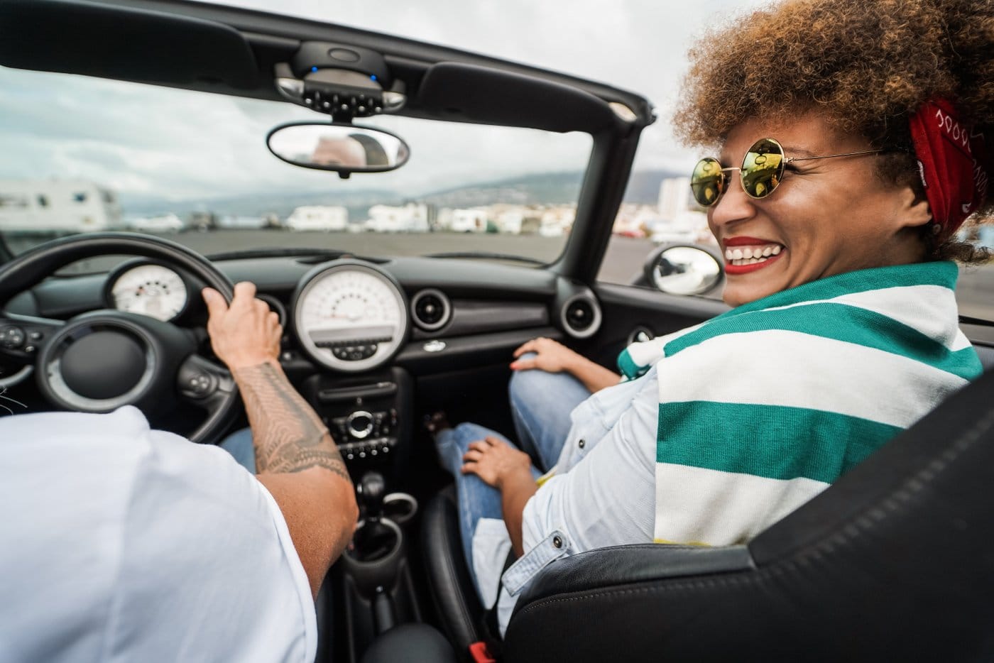 Happy couple driving in a convertible car