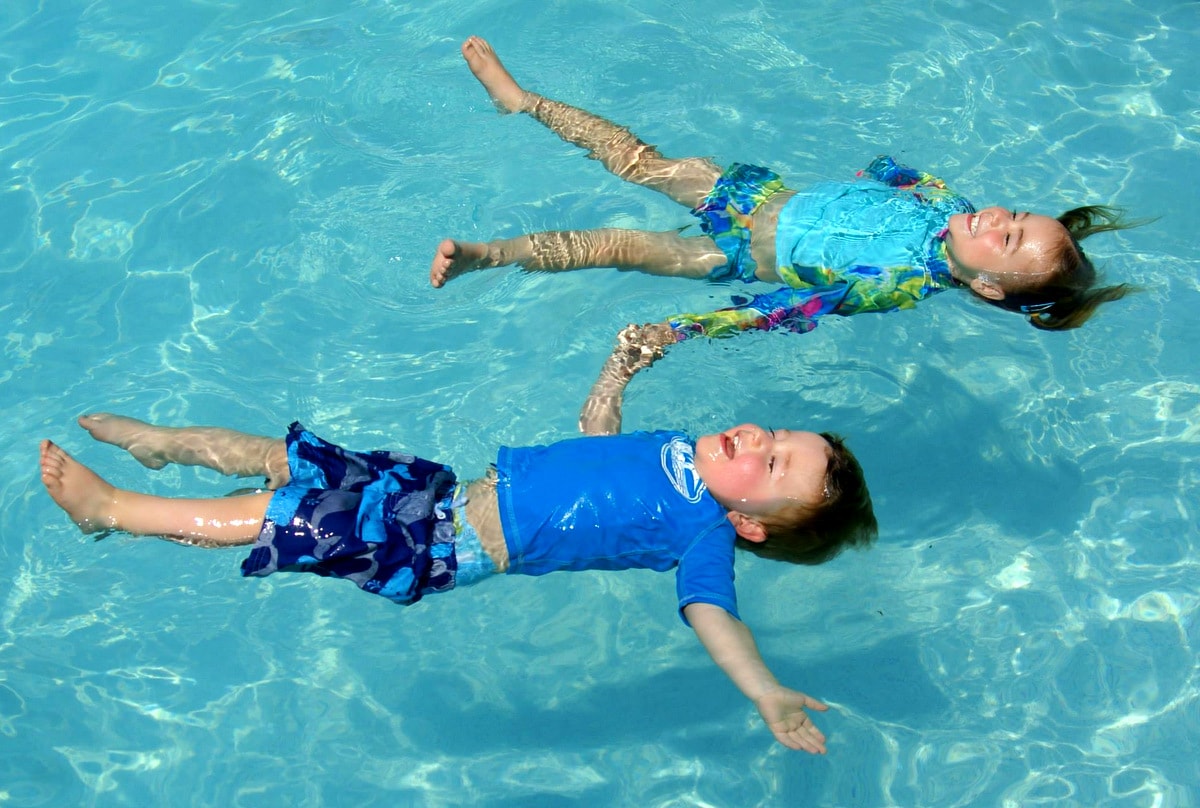 Kids safely floating in a swimming pool