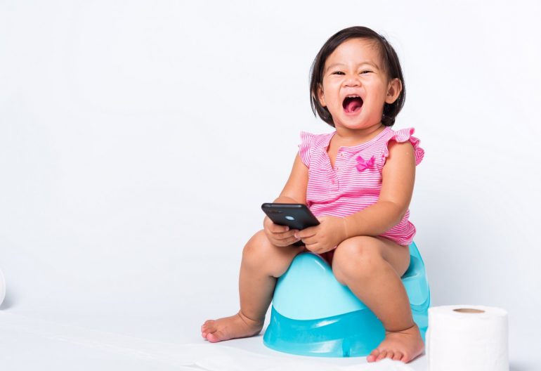 Little girl on mini toilet learning potty training