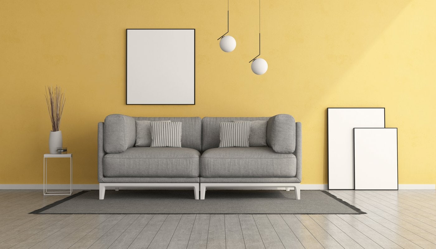 Living room with yellow wall and grey sofa