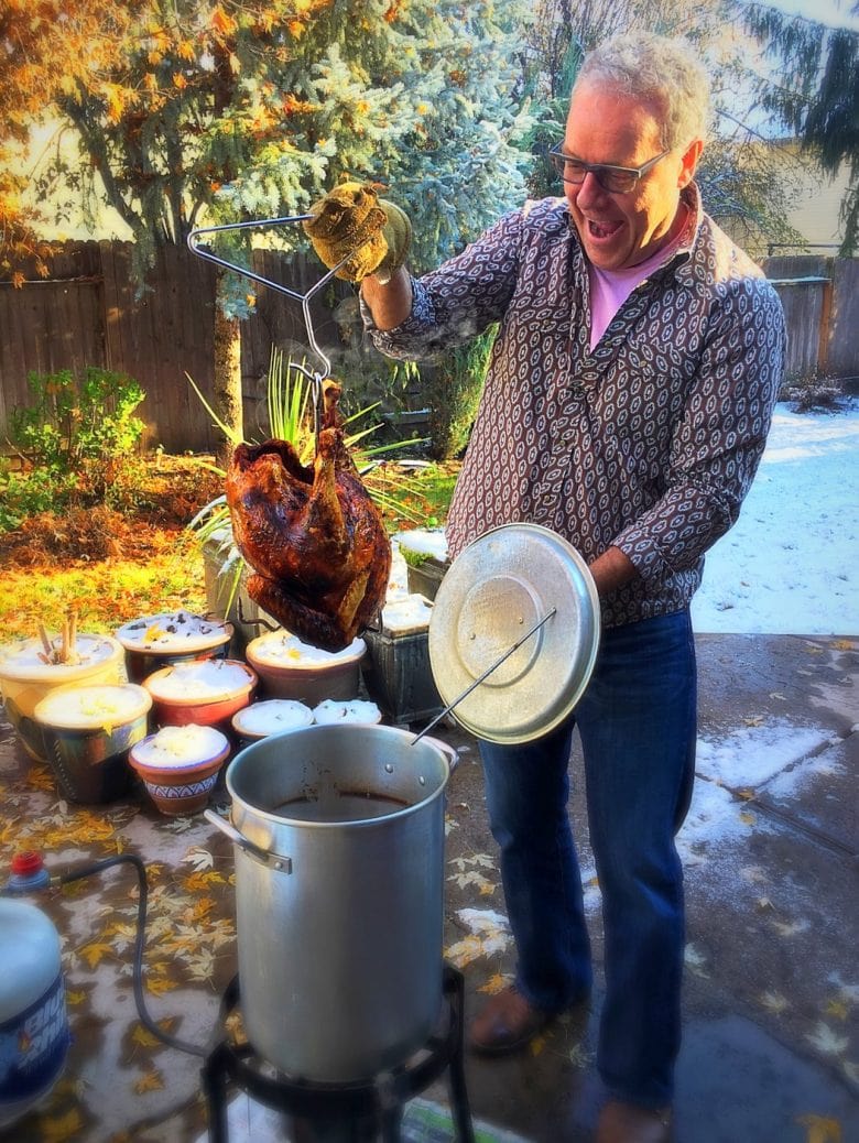 Man deep frying a turkey in the backyard