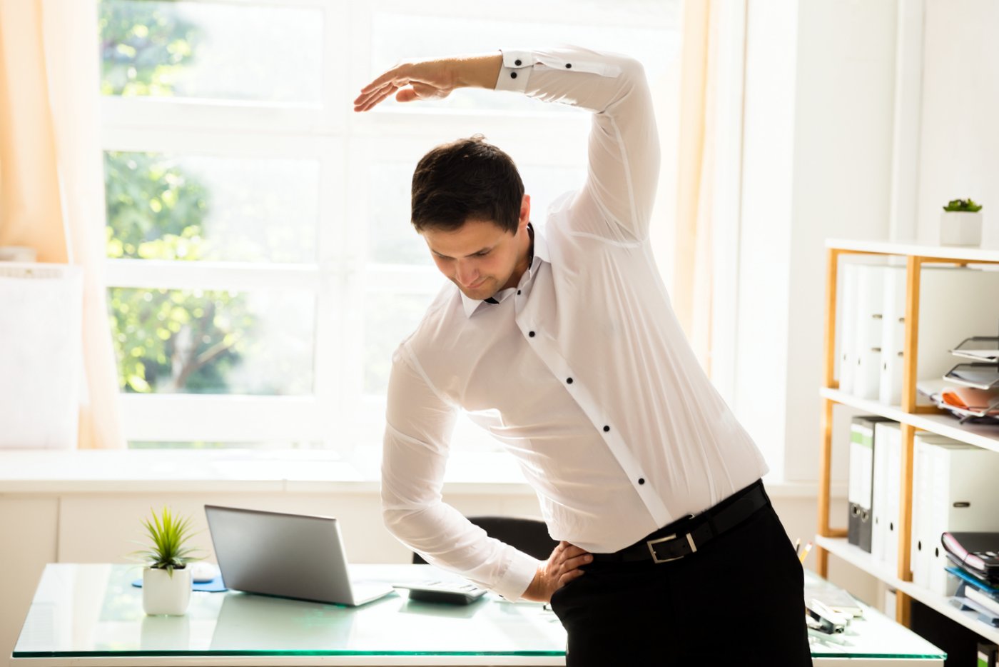 Man stretching and exercising at work