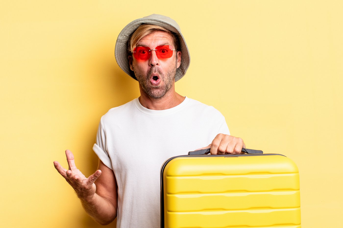 Man tourist with yellow suitcase