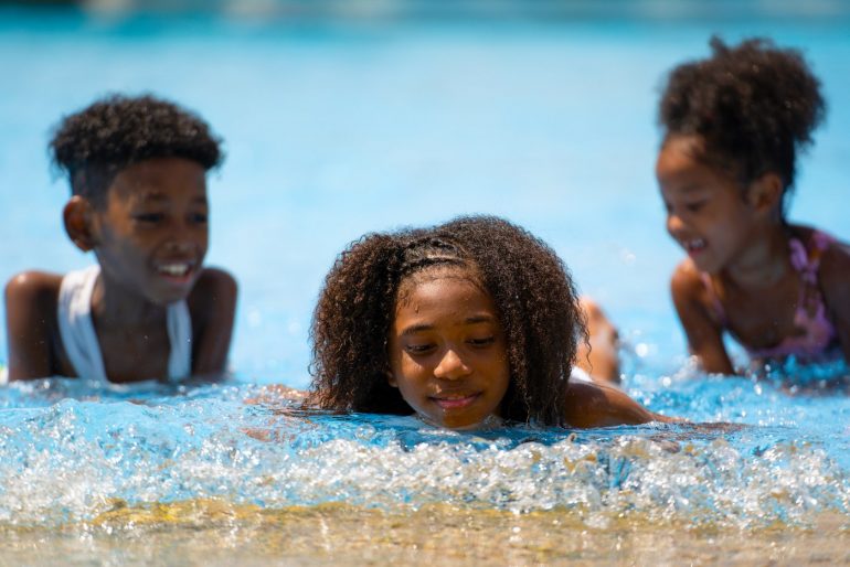 Kids swimming near a beach