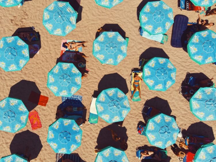 Sunbathers under beach umbrellas