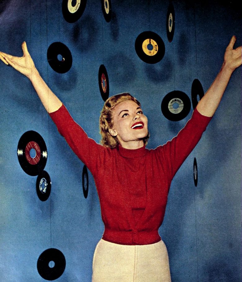 Teen girl in 1950s with 45 RPM singles