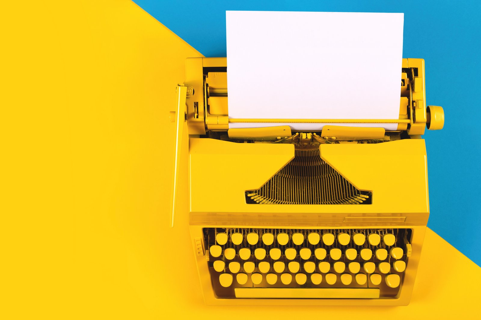 Vintage typewriter on blue and yellow background - For writers