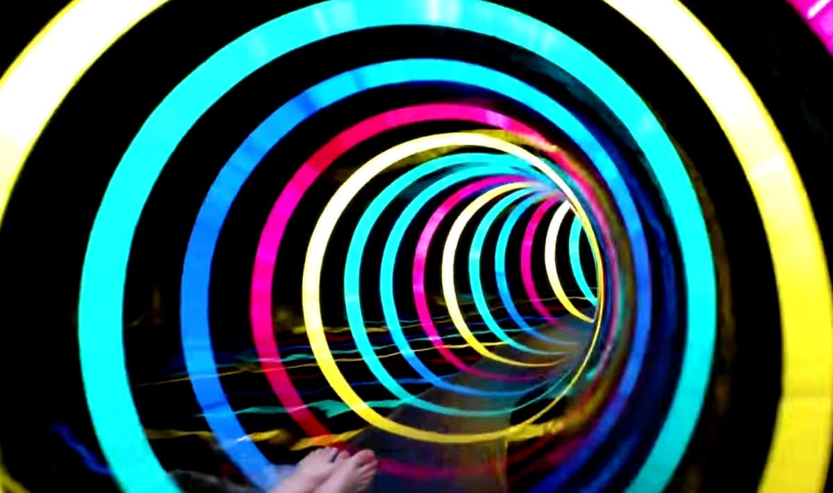 Water slide tunnel with trippy LED rainbow effect lights - Wonka-style