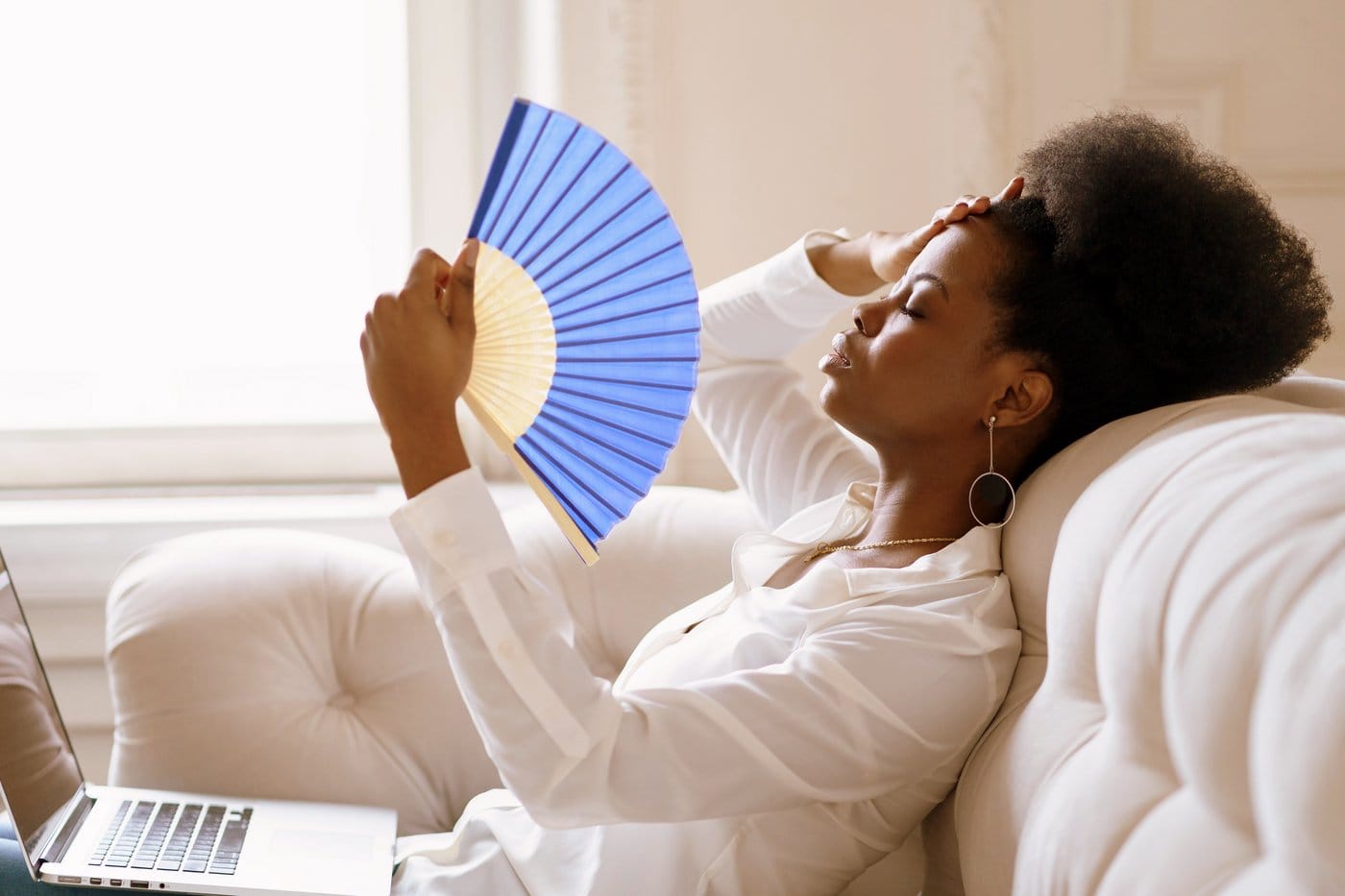 Woman fanning herself on a hot day