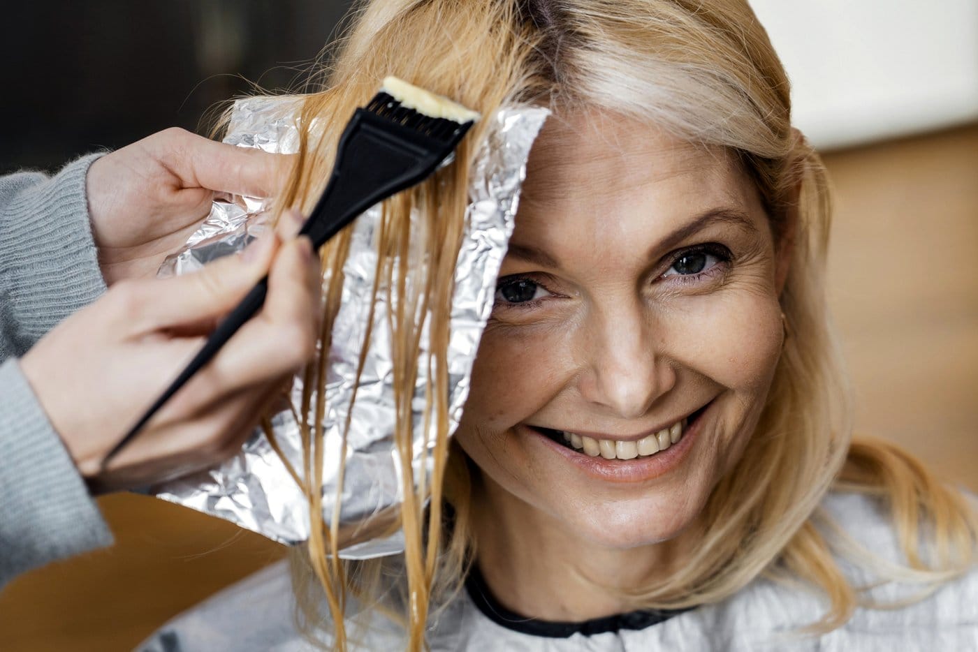 Woman getting foil hair highlights