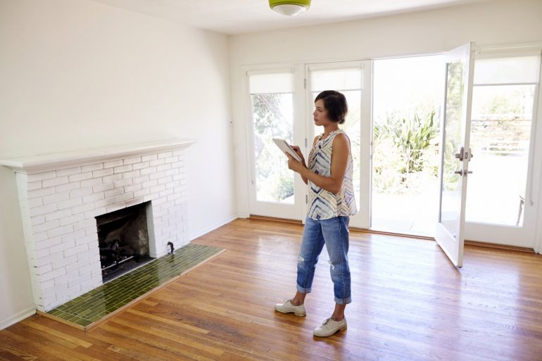 Woman looking at her empty new home