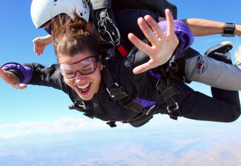 Woman skydiving with trainer
